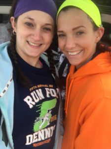 two female race participants smiling